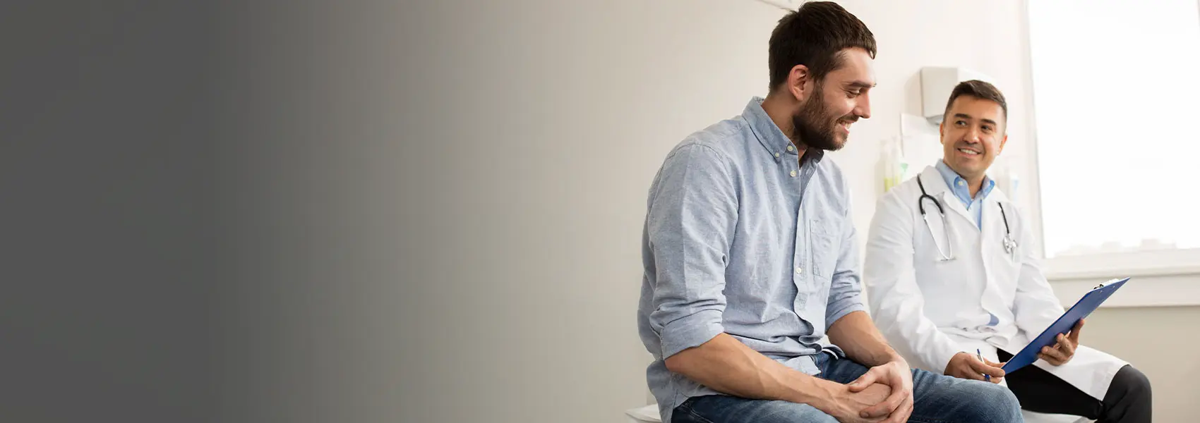 Man smiling with physician